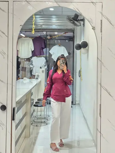 Maroon shirt with white trousers, photographed as a mirror selfie inside Selfie Western Wear