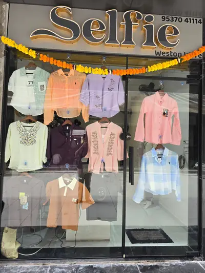 Selfie Western Wear storefront at Prime Arcade, with the Selfie sign and tops and shirts on display
